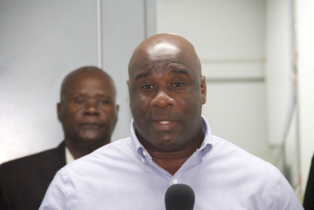 Hon. Alexis Jeffers, Minister responsible for Public Utilities in the Nevis Island Administration delivering remarks at a ceremony to commission a MP36 2.5 megawatt generating set at the Prospect Power Plant on December 21, 2016 while Chairman of the Nevis Electricity Company Limited’s Board of Directors Hon. Farrell Smithen looks on